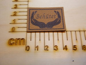 Kunstlederlabel "Behütet"